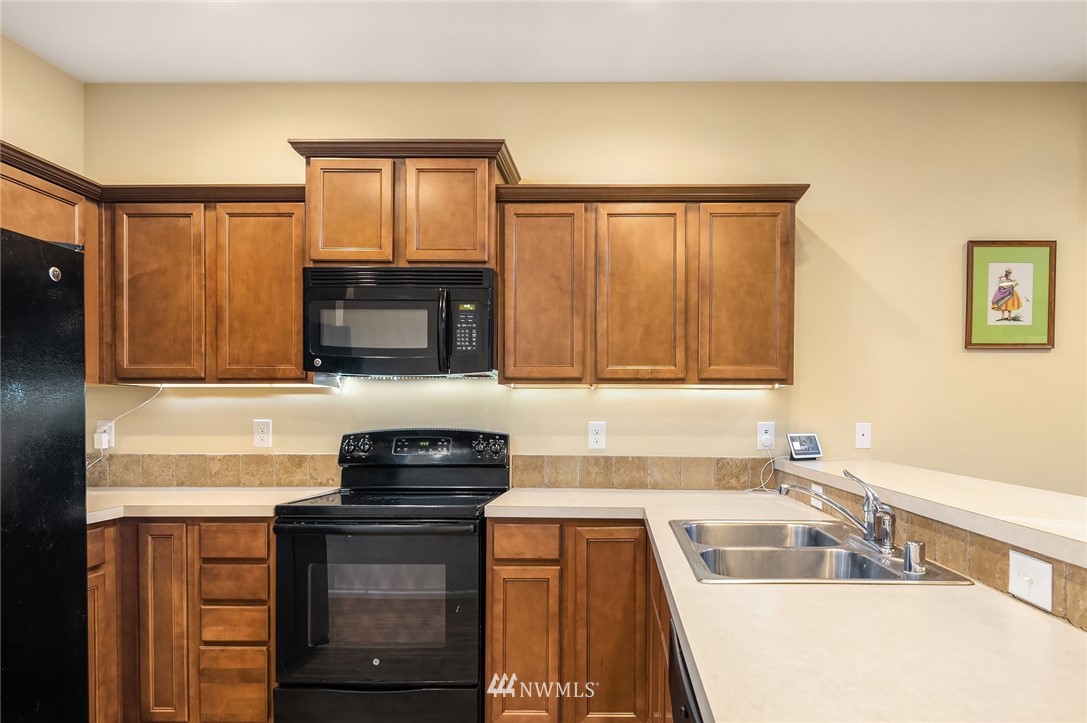 4738 Court R Tacoma, WA 98404 - Photo 12 of 32 a kitchen with a sink stove and microwave