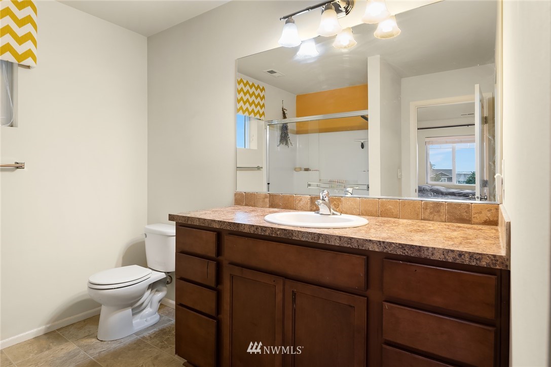 4738 Court R Tacoma, WA 98404 - Photo 20 of 32 a bathroom with a granite countertop sink a toilet and a mirror