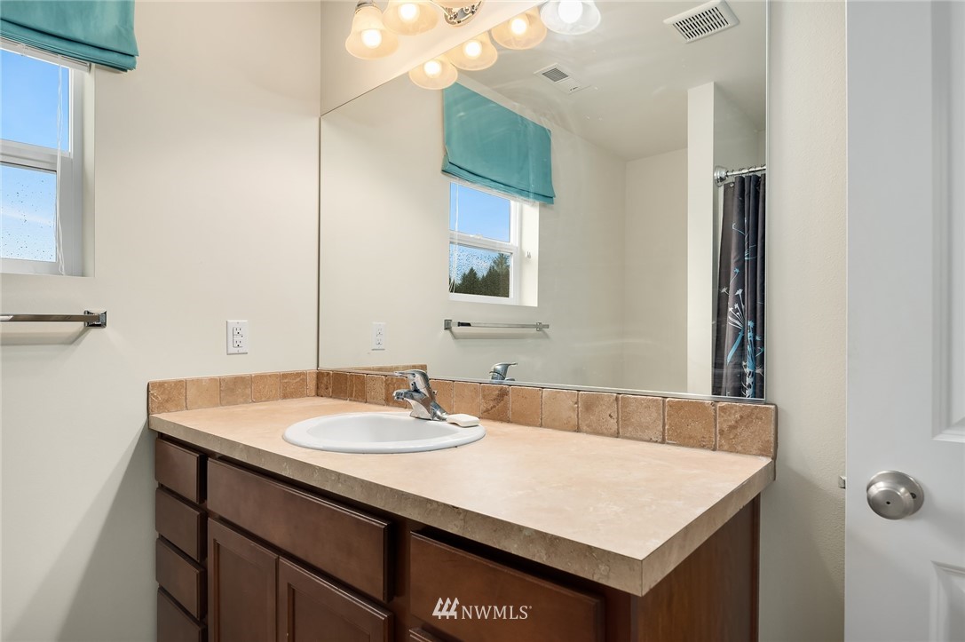 4738 Court R Tacoma, WA 98404 - Photo 24 of 32 a bathroom with a sink vanity and a mirror