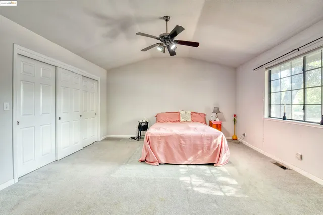 a bathroom with a granite countertop sink a toilet and a mirror