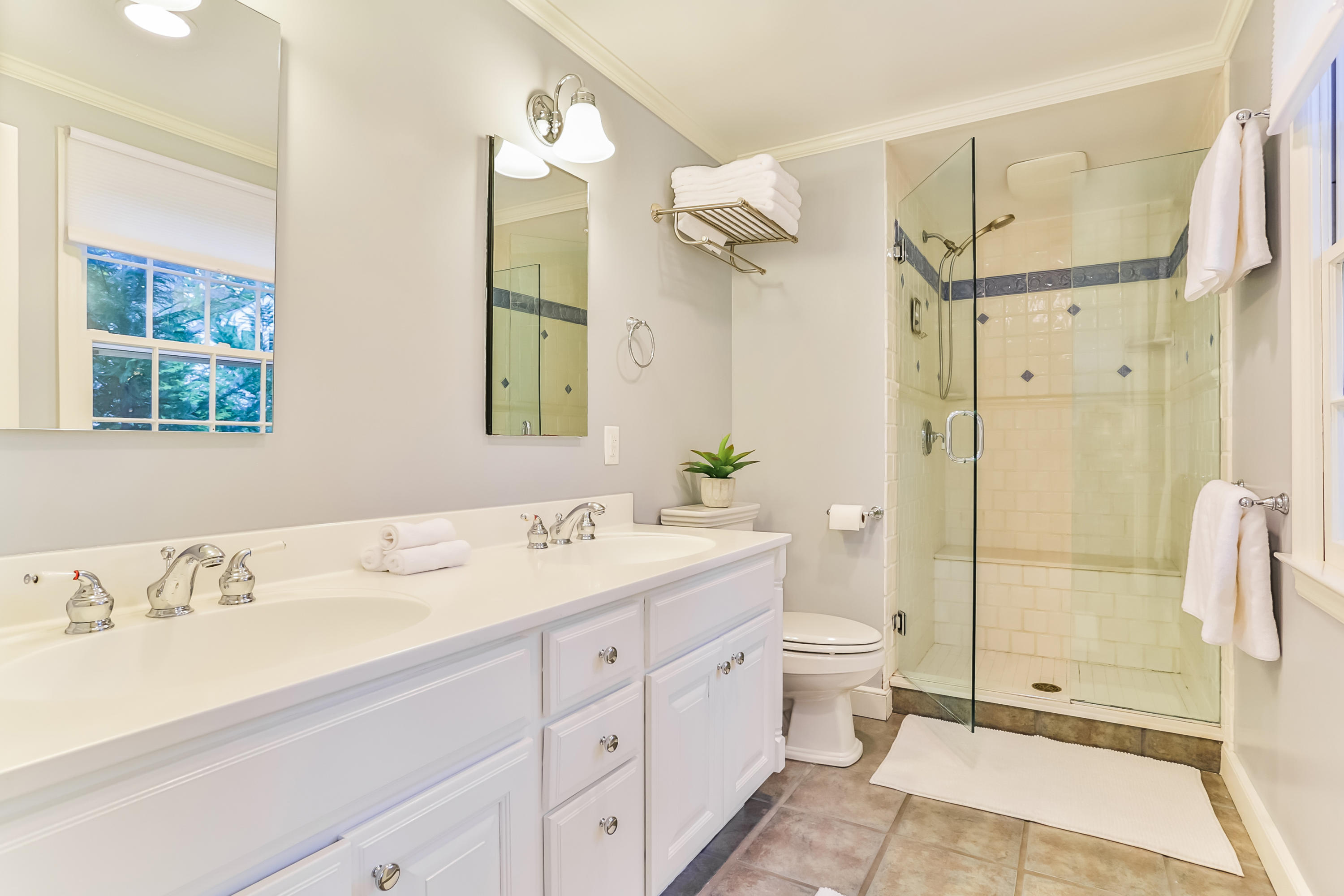 23 Rocaton Road Darien, CT 06820 - Photo 19 of 36 a bathroom with a double vanity sink toilet and shower