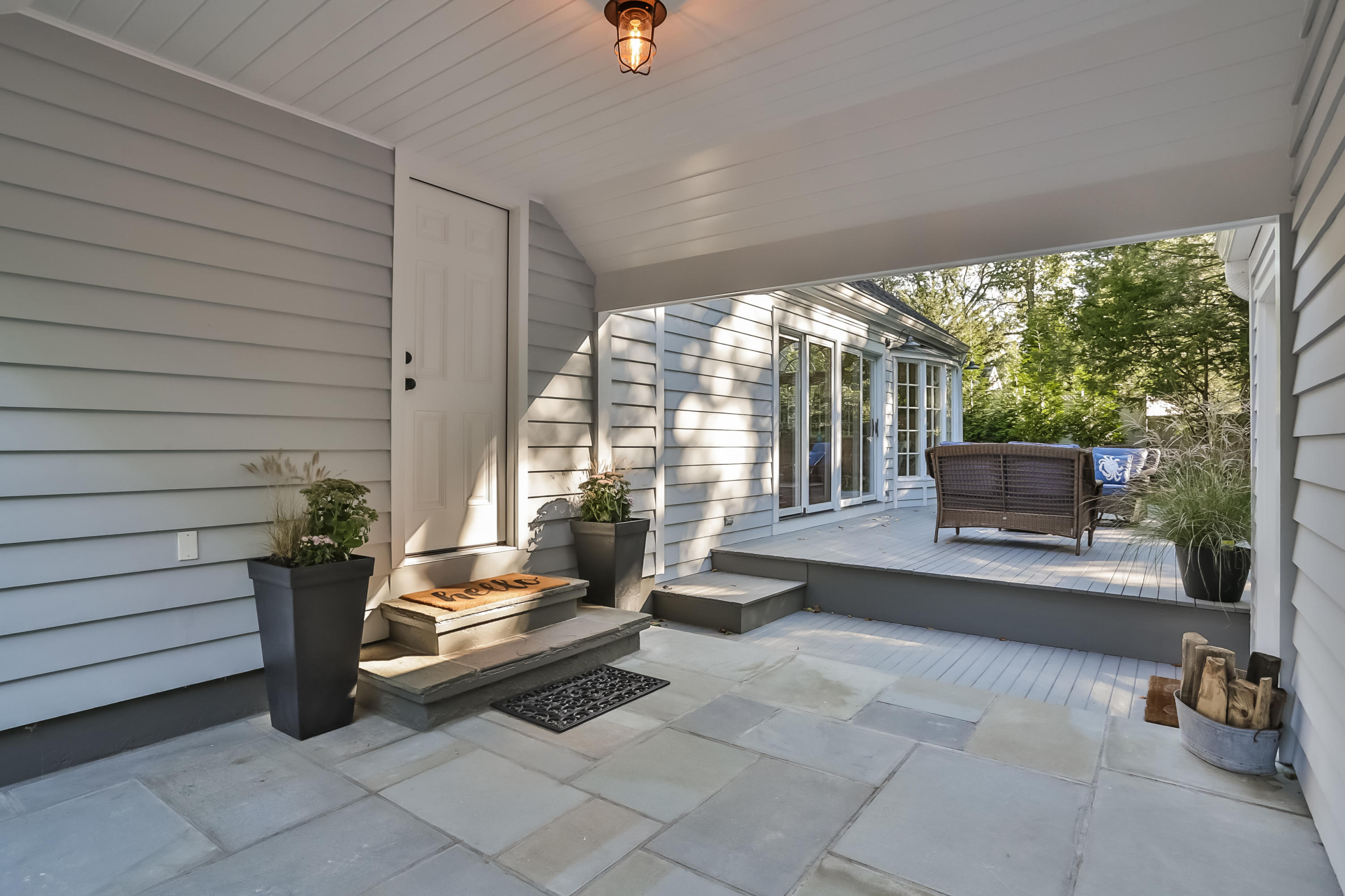 23 Rocaton Road Darien, CT 06820 - Photo 9 of 36 a building outdoor space with patio furniture and potted plants
