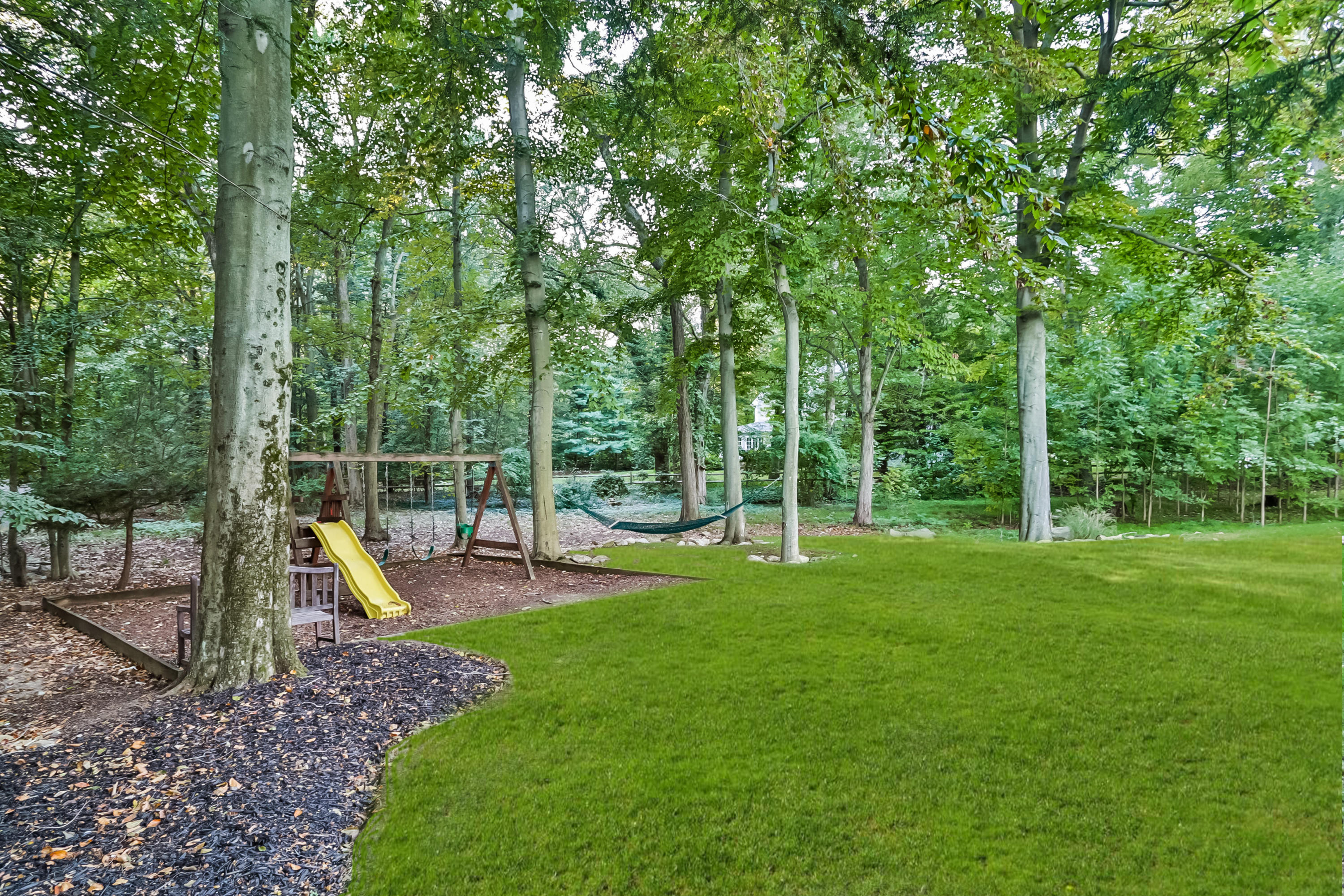 23 Rocaton Road Darien, CT 06820 - Photo 10 of 36 a view of a backyard with swings