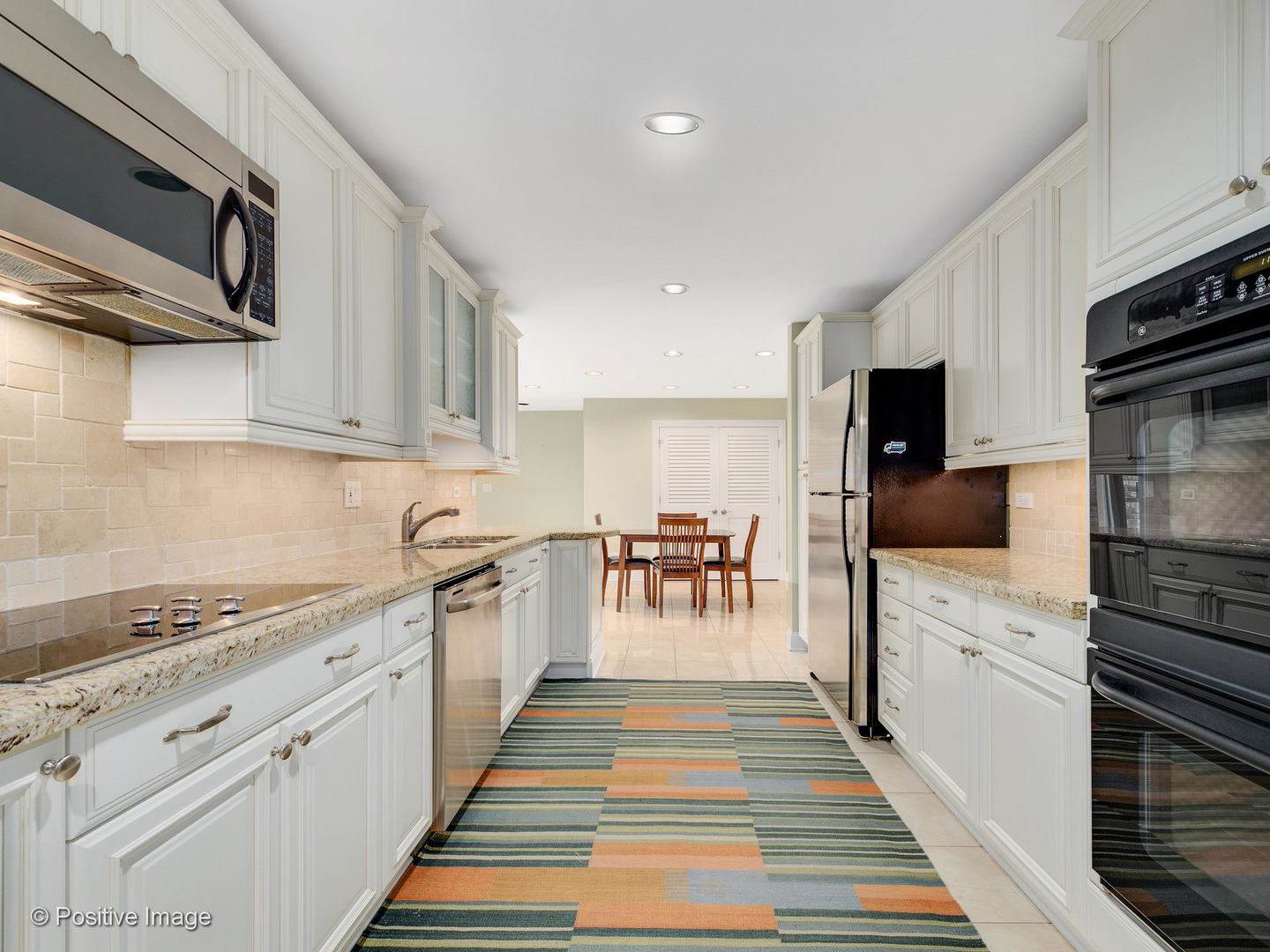 1228 Indian Trail Road Hinsdale, IL 60521 - Photo 8 of 27 a kitchen with white cabinets and appliances