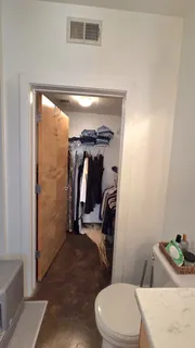 a bathroom with a toilet and a shower