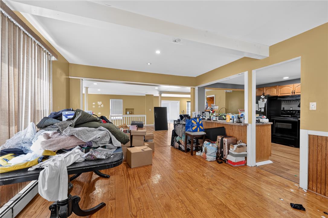 2882 Locust Ridge Road Pocono Lake, PA 18347 - Photo 23 of 45 Hardwood floors stretch across this open-concept interior, bathed in light from the wide windows.
