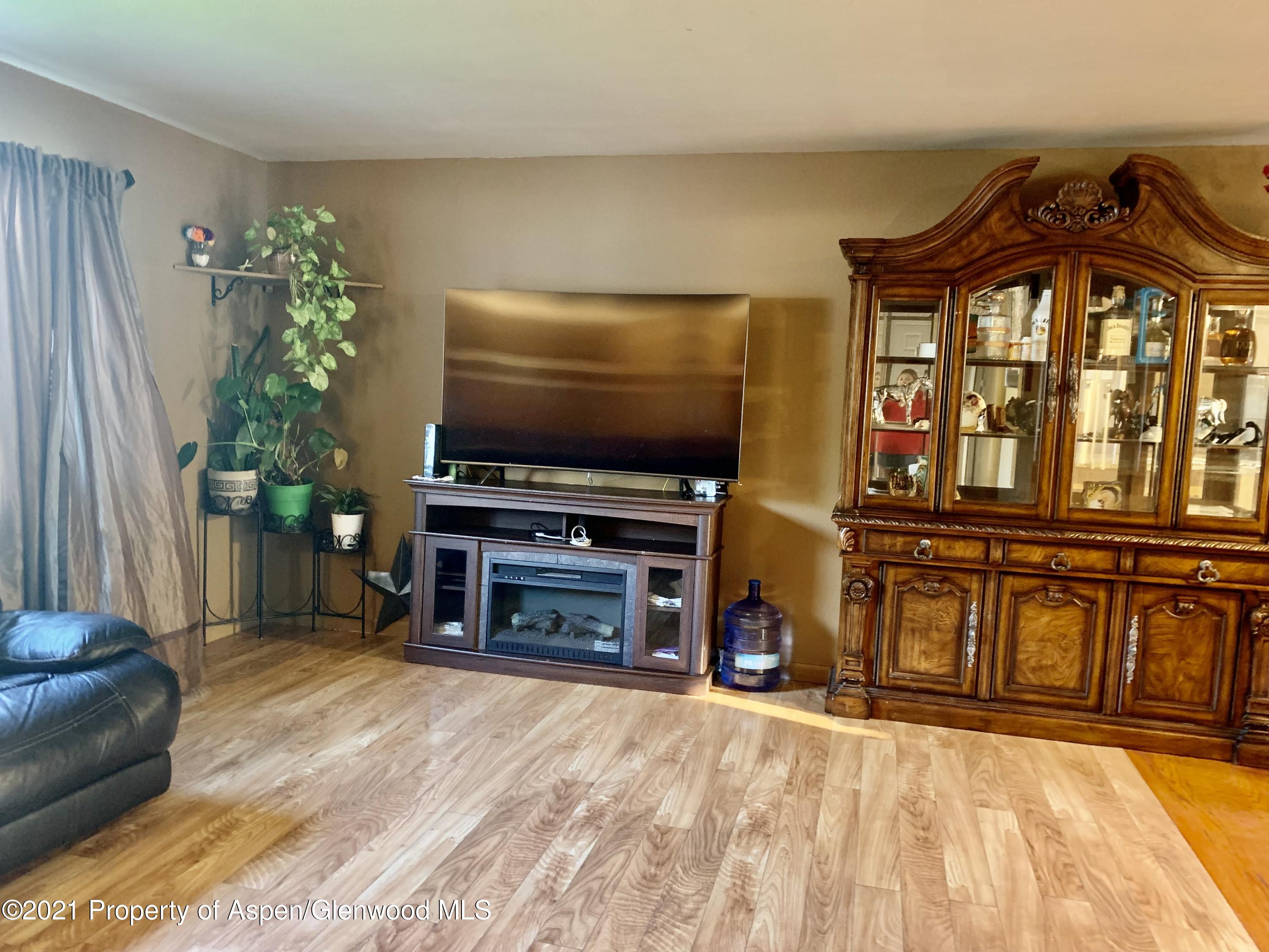 615 Ash Avenue Rifle, CO 81650 - Photo 8 of 24 a living room with furniture and a flat screen tv
