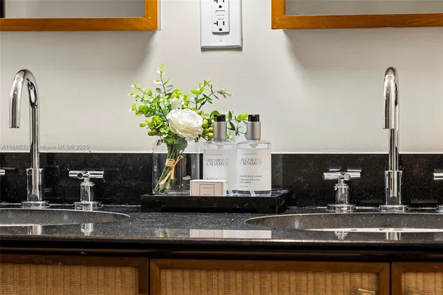 a kitchen with granite countertop a sink stainless steel appliances and cabinets