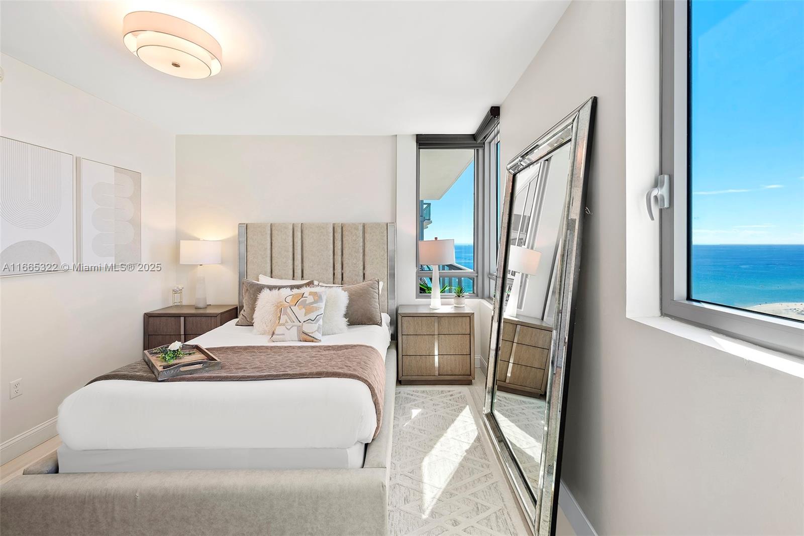 101 20th Street, Unit 2604 Miami Beach, FL 33139 - Photo 21 of 27 a bedroom with a bed and a mirror