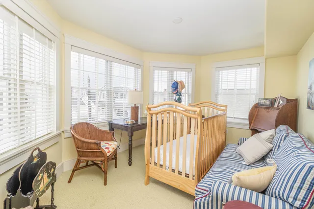 a view of a chair and table on the roof deck