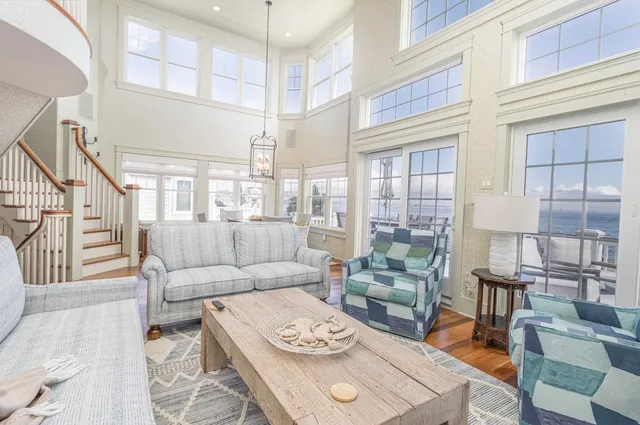 a dining room with furniture a chandelier and wooden floor