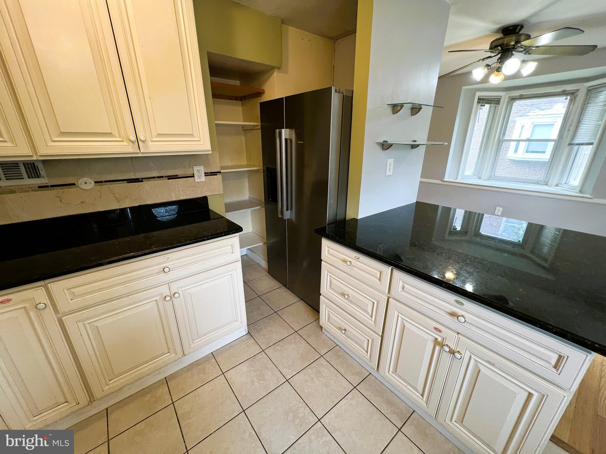 3705 Bancroft Road Baltimore, MD 21215 - Photo 10 of 50 a kitchen with granite countertop white cabinets and refrigerator