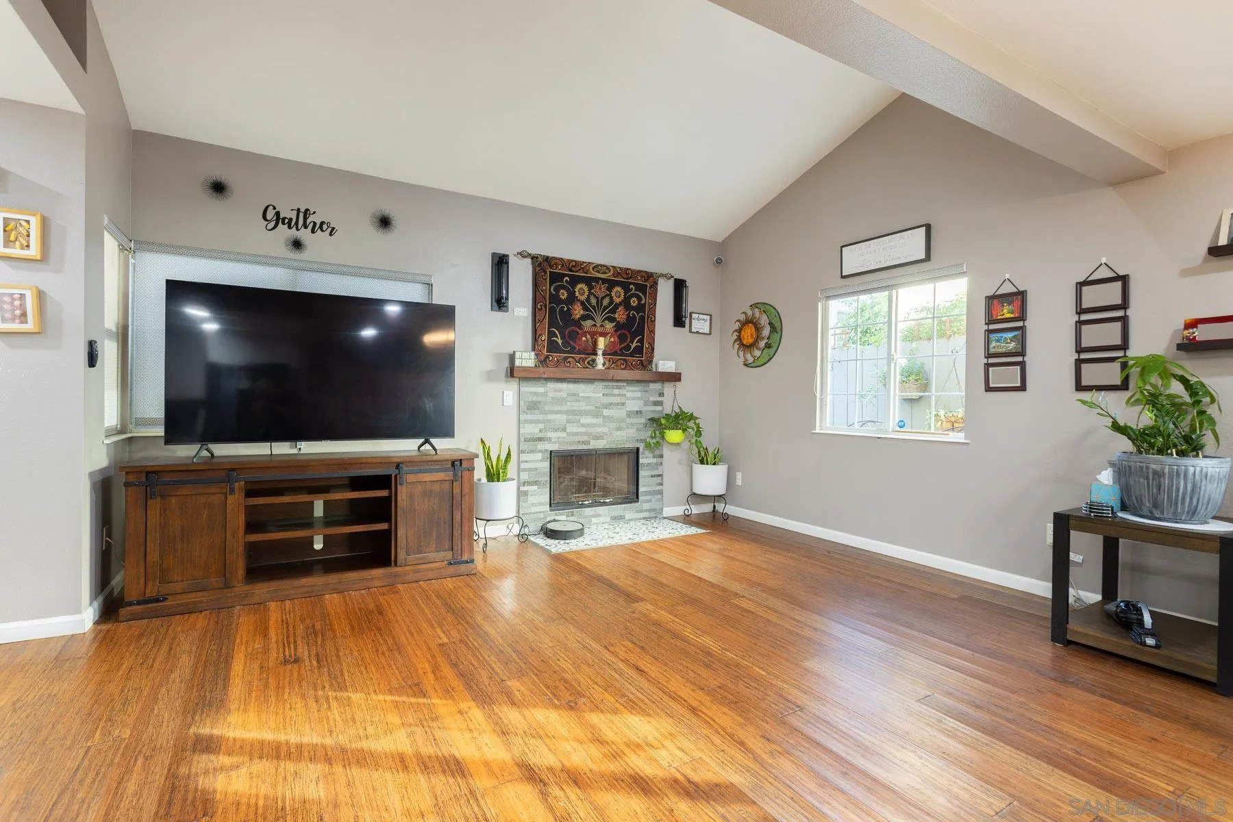 3142 Lamar Court Spring Valley, CA 91977 - Photo 3 of 16 a living room with furniture a flat screen tv and a fireplace