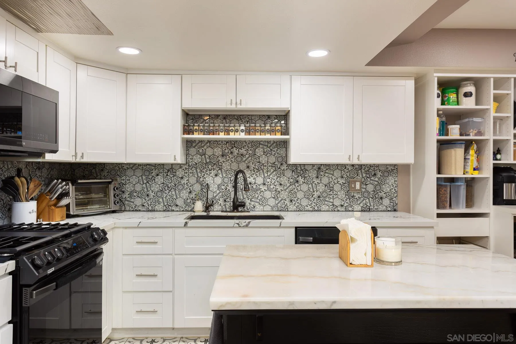 3142 Lamar Court Spring Valley, CA 91977 - Photo 6 of 16 a kitchen with stainless steel appliances granite countertop a sink stove and cabinets