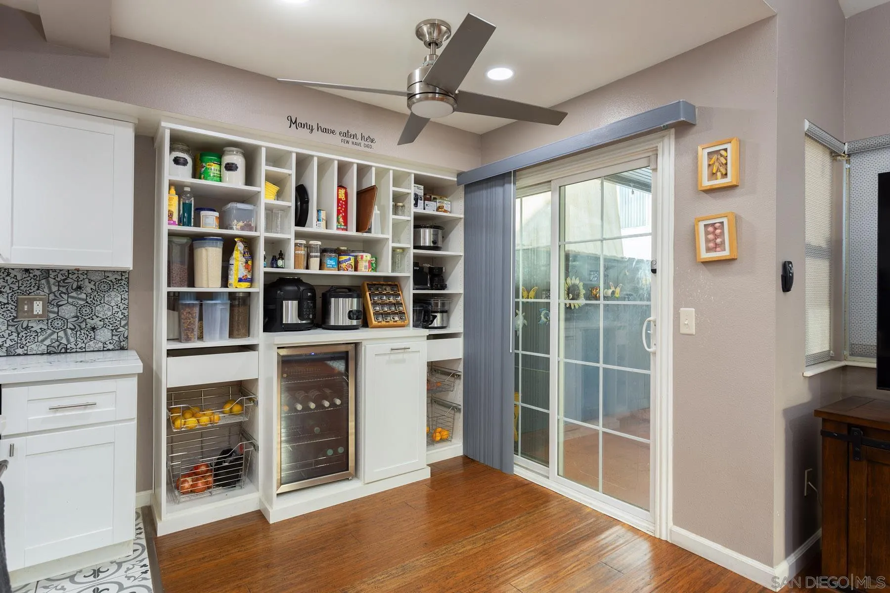 3142 Lamar Court Spring Valley, CA 91977 - Photo 7 of 16 a view of an empty room with shelves and wooden floor