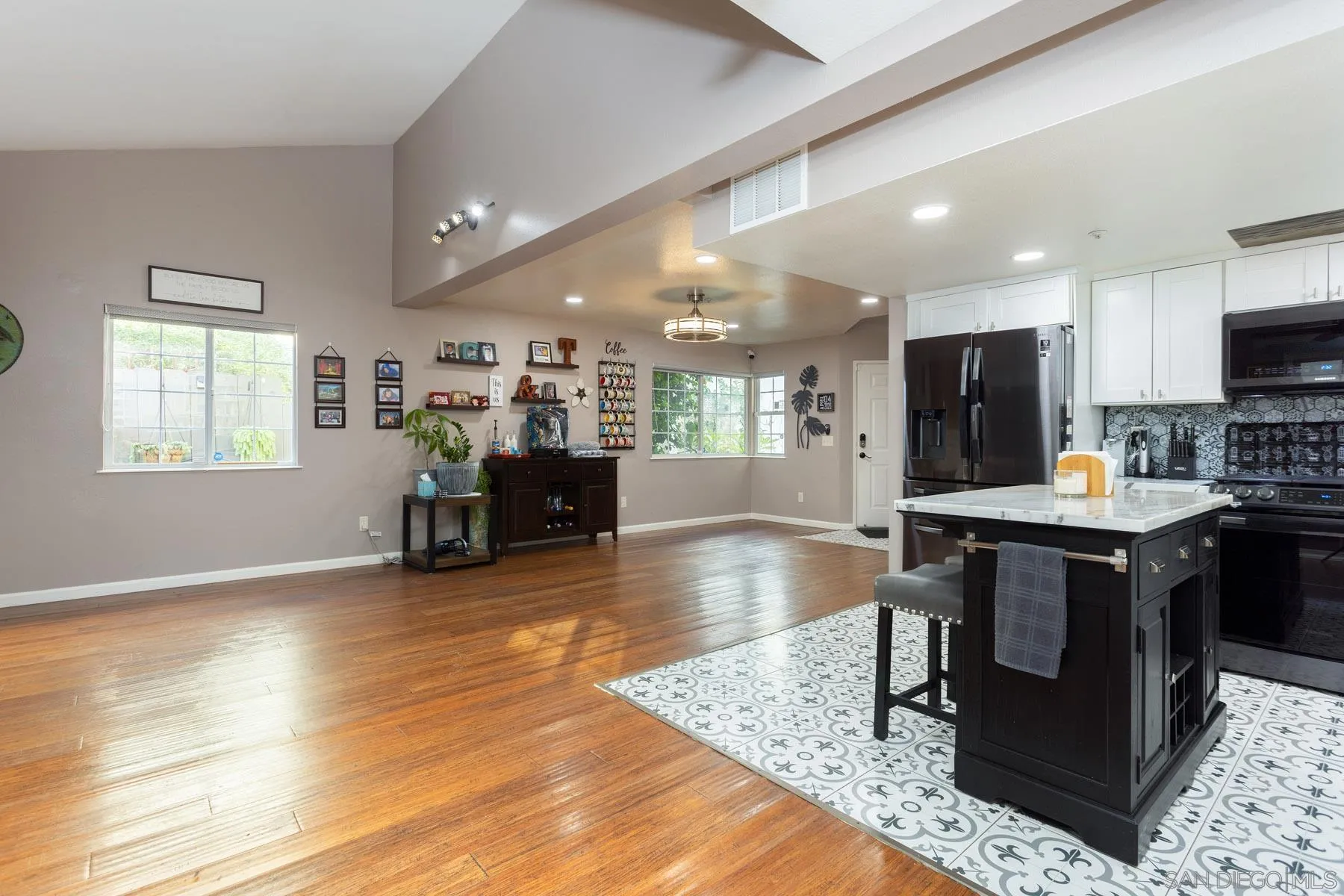 3142 Lamar Court Spring Valley, CA 91977 - Photo 9 of 16 a kitchen with stainless steel appliances granite countertop a stove refrigerator and cabinets