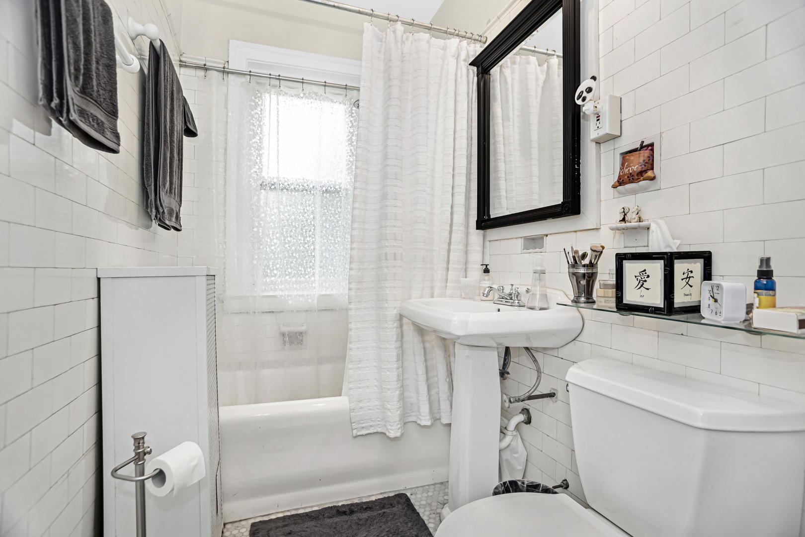 520 Sheridan Road, Unit 2A Evanston, IL 60202 - Photo 14 of 16 a bathroom with a sink toilet a mirror and shower