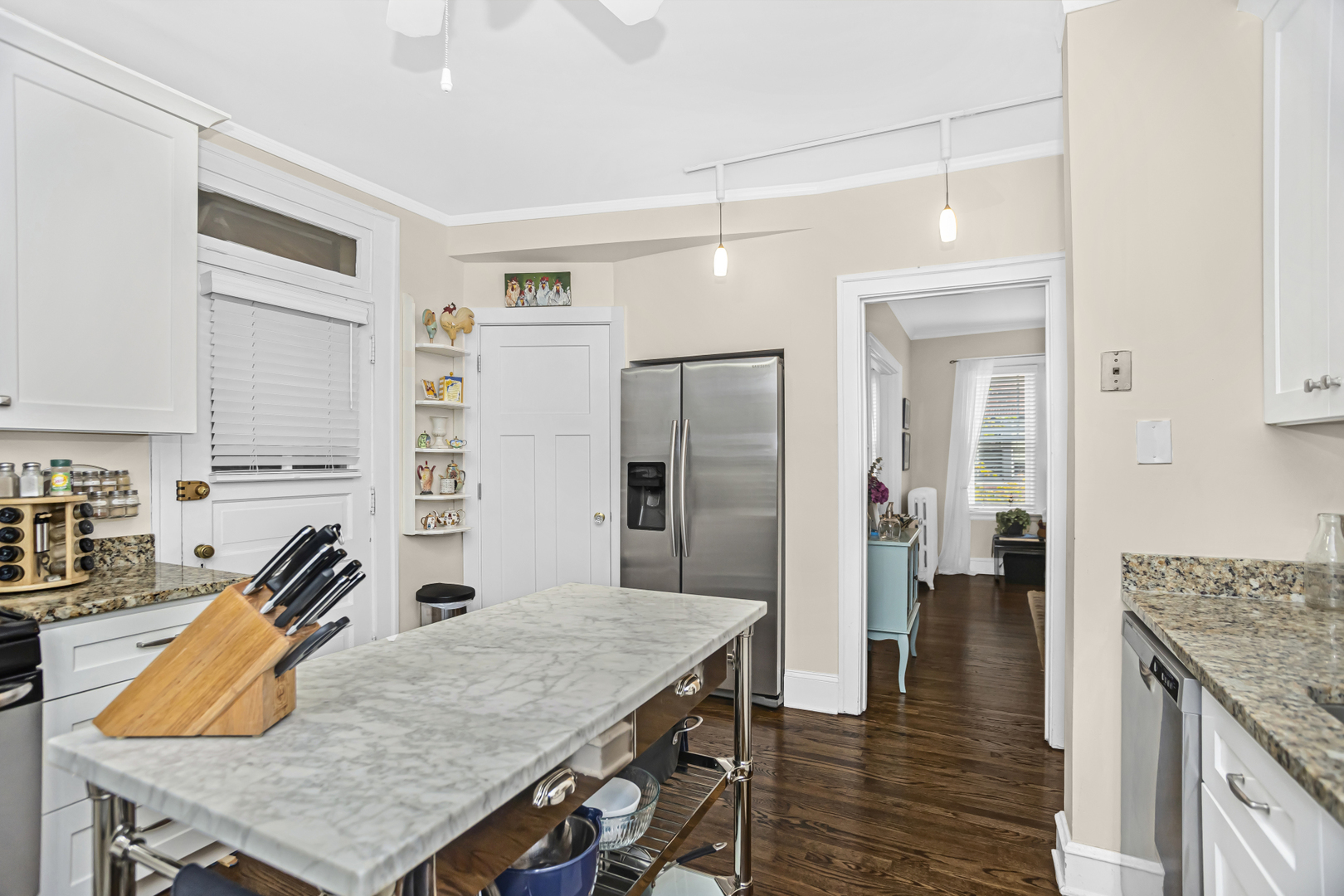 520 Sheridan Road, Unit 2A Evanston, IL 60202 - Photo 9 of 16 a kitchen with stainless steel appliances granite countertop wooden floor window and refrigerator