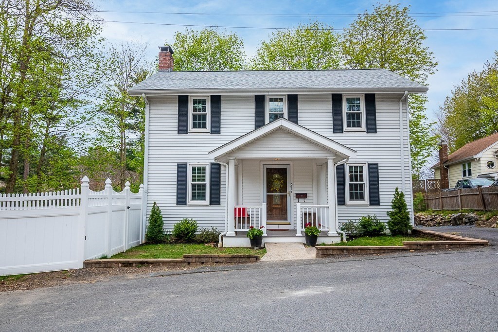 217 Lawrence Street Canton, MA 02021 - Photo 1 of 34 a front view of a house with a yard and potted plants
