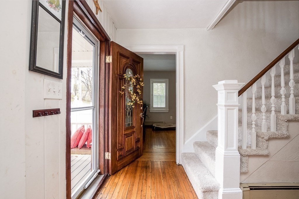 217 Lawrence Street Canton, MA 02021 - Photo 14 of 34 a view of a hallway with wooden floor and staircase