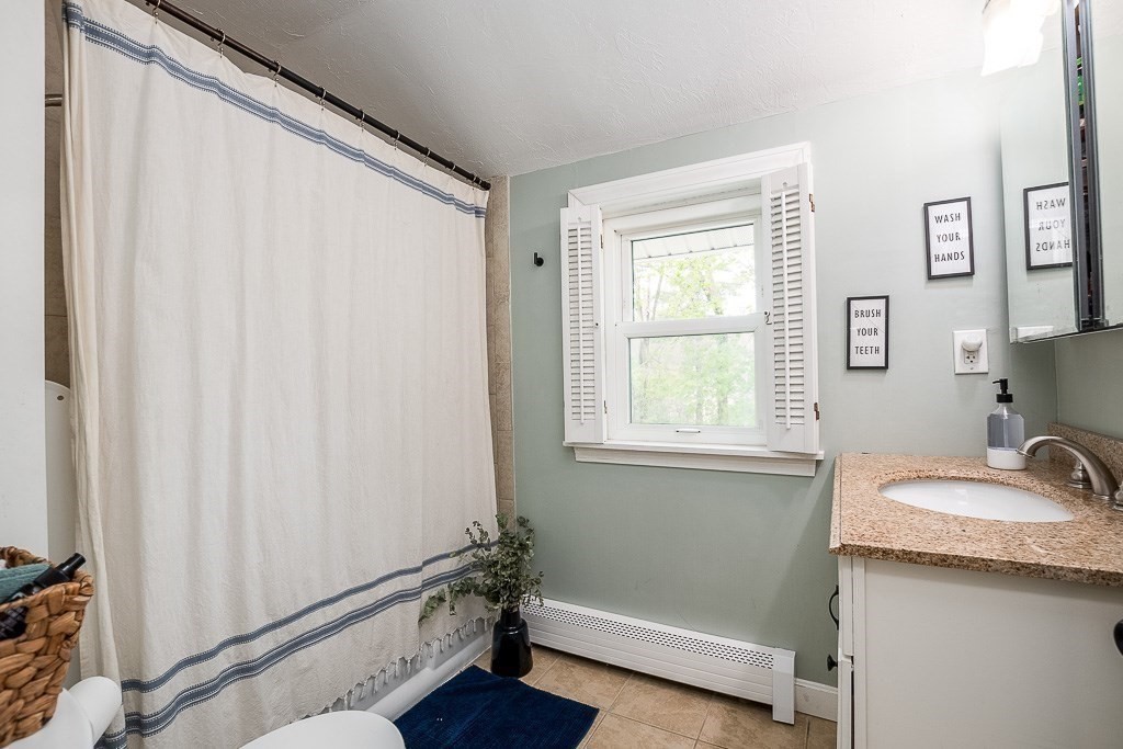 217 Lawrence Street Canton, MA 02021 - Photo 18 of 34 a bathroom with a granite countertop sink and a mirror