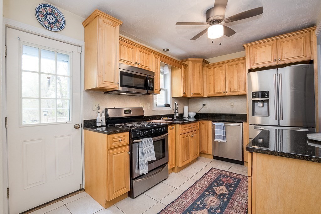 217 Lawrence Street Canton, MA 02021 - Photo 10 of 34 a kitchen with stainless steel appliances granite countertop a stove a sink and a refrigerator