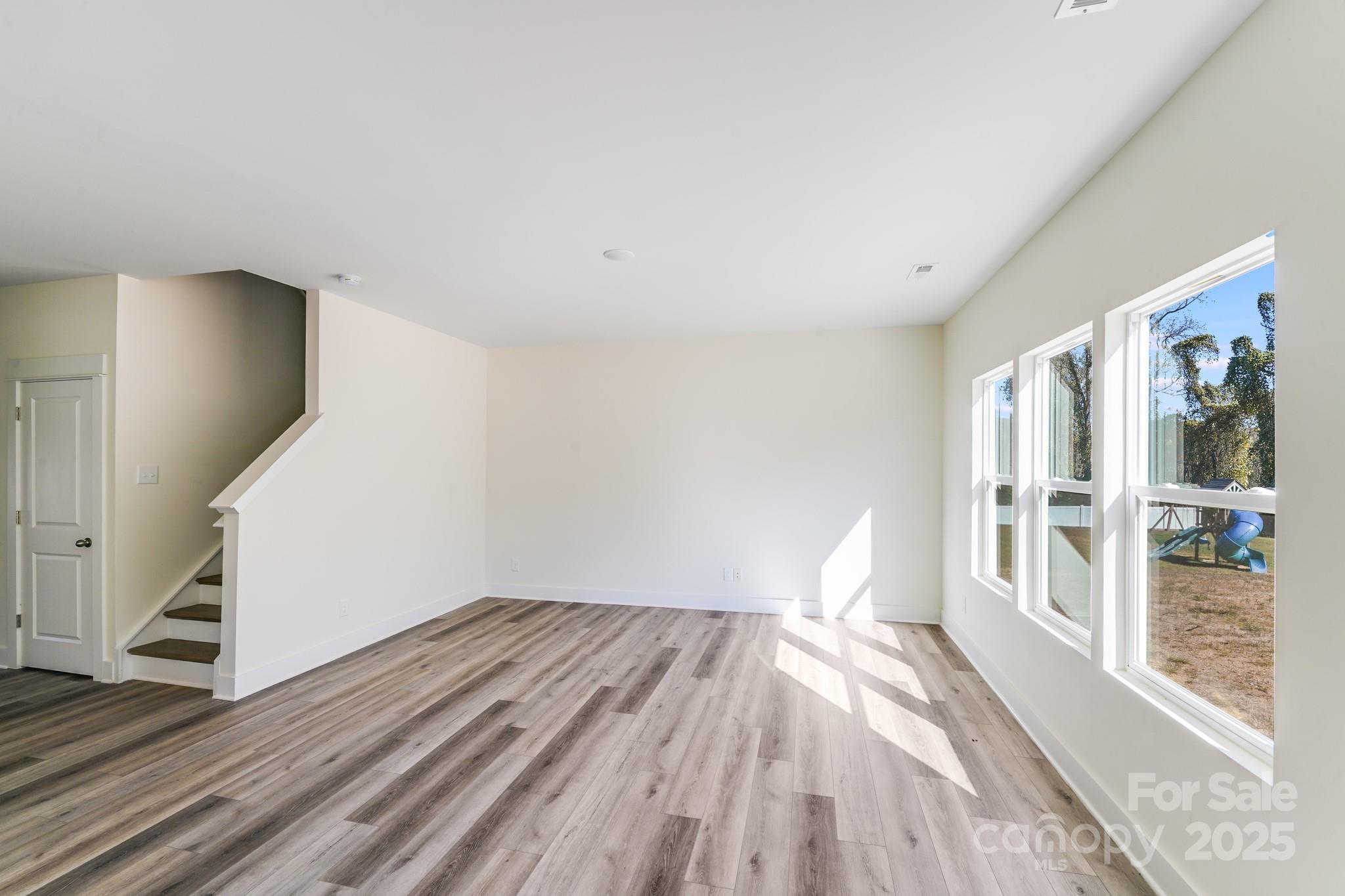 212 Sugar Hill Road Troutman, NC 28166 - Photo 12 of 47 a view of empty room with wooden floor