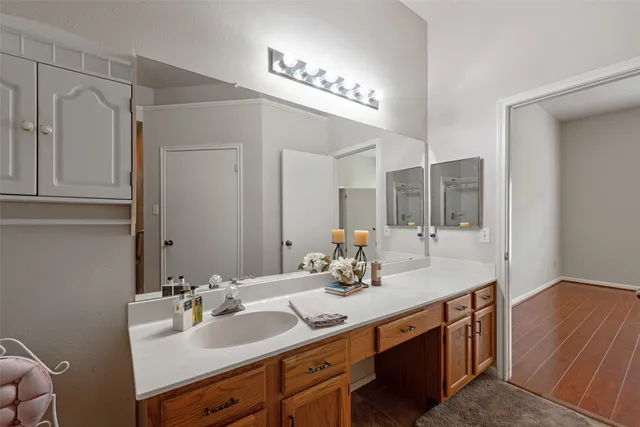 a bathroom with a double vanity sink mirror and shower