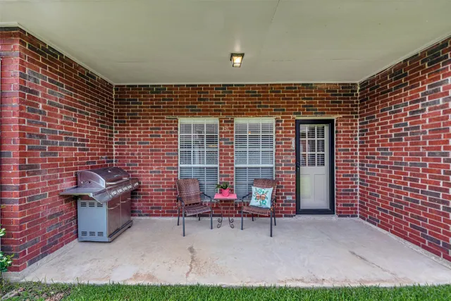 a view of a chairs and table in backyard of the house