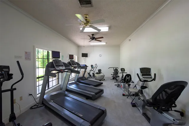 a room with pool table and windows