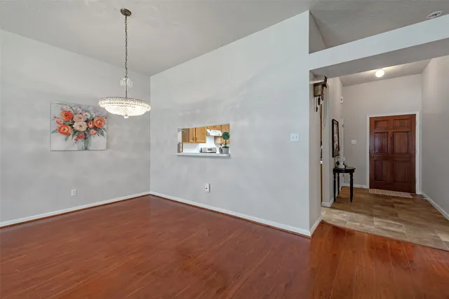 a view of a room with window and hardwood floor