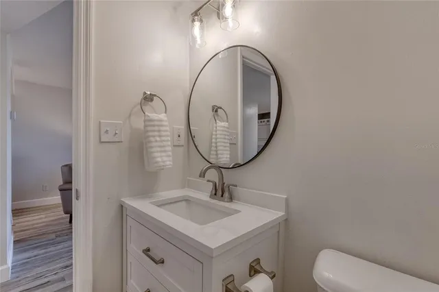 a bathroom with a sink a mirror and a toilet