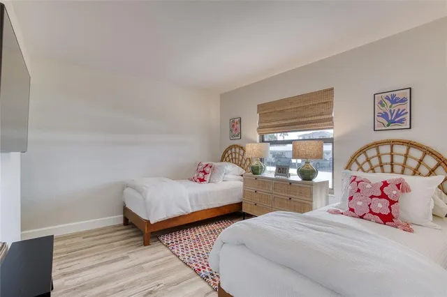 a bedroom with two beds and a window