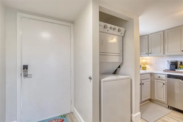 a kitchen with a refrigerator sink and cabinets