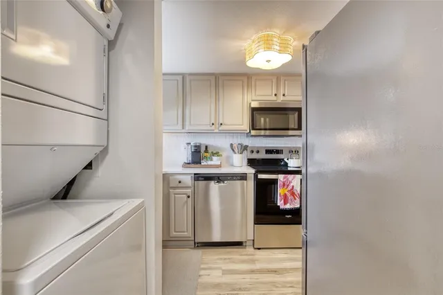 a kitchen with a refrigerator stove and microwave