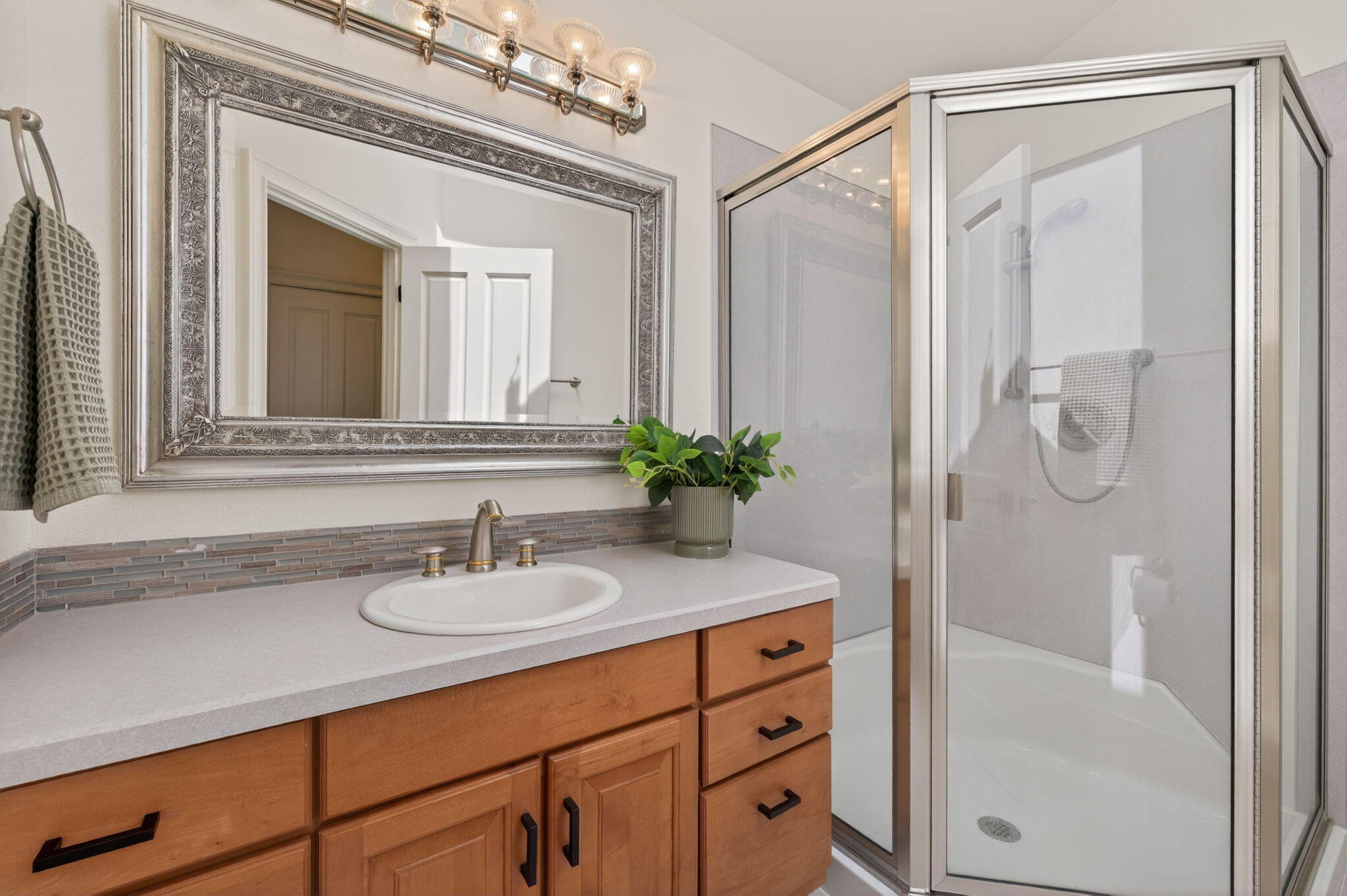 20180 Winston Loop Bend, OR 97703 - Photo 35 of 59 a bathroom with a granite countertop sink a mirror a vanity and a shower
