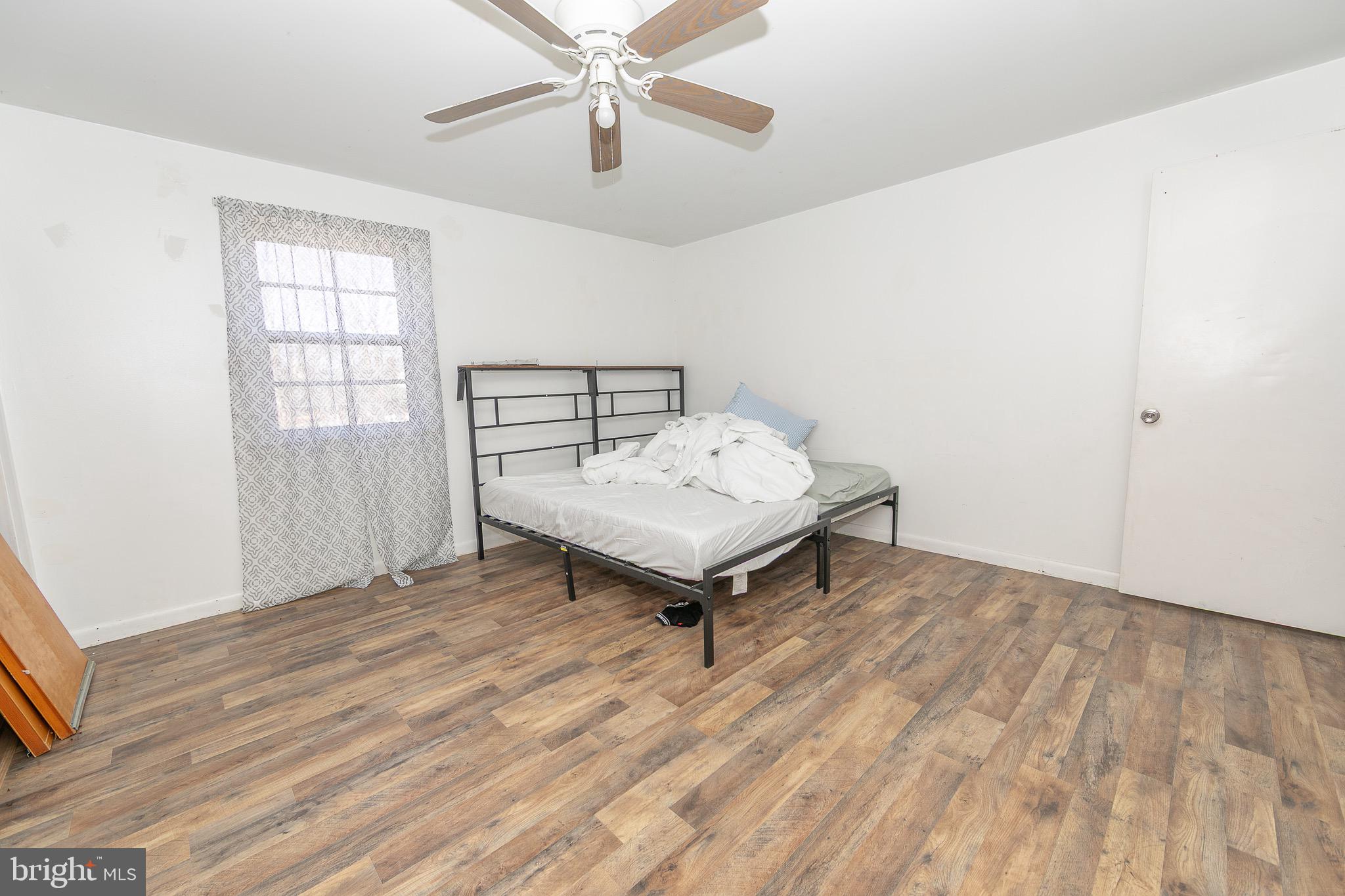 23 School Lane Carneys Point, NJ 08069 - Photo 11 of 21 a living room with a bed furniture and a window