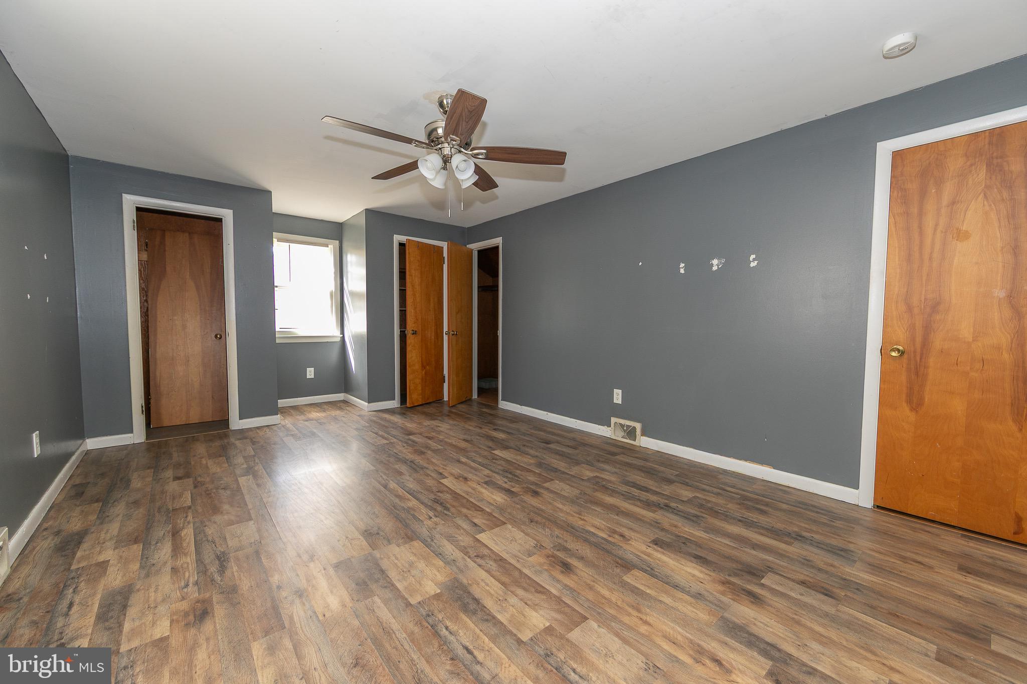 23 School Lane Carneys Point, NJ 08069 - Photo 17 of 21 a view of an empty room with wooden floor and a window