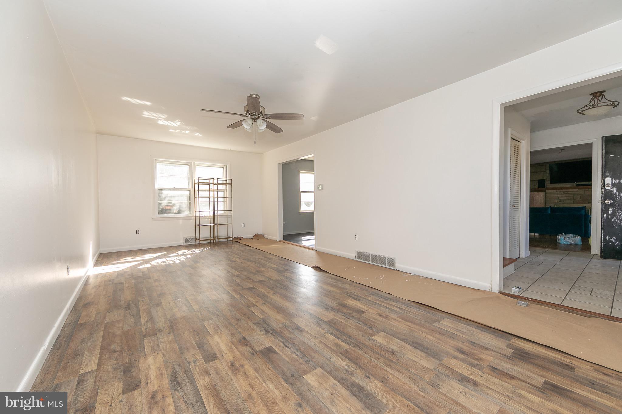 23 School Lane Carneys Point, NJ 08069 - Photo 5 of 21 an empty room with wooden floor and windows