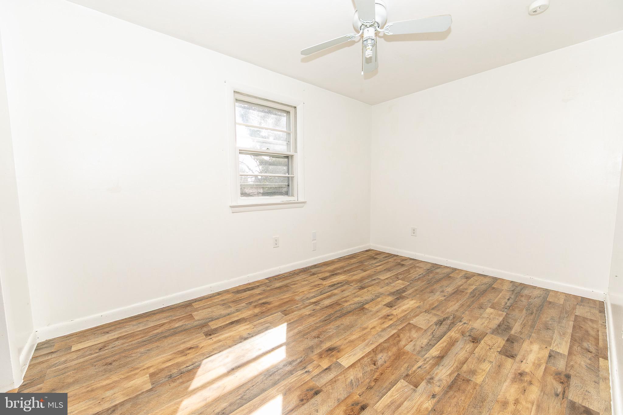 23 School Lane Carneys Point, NJ 08069 - Photo 10 of 21 an empty room with wooden floor and windows