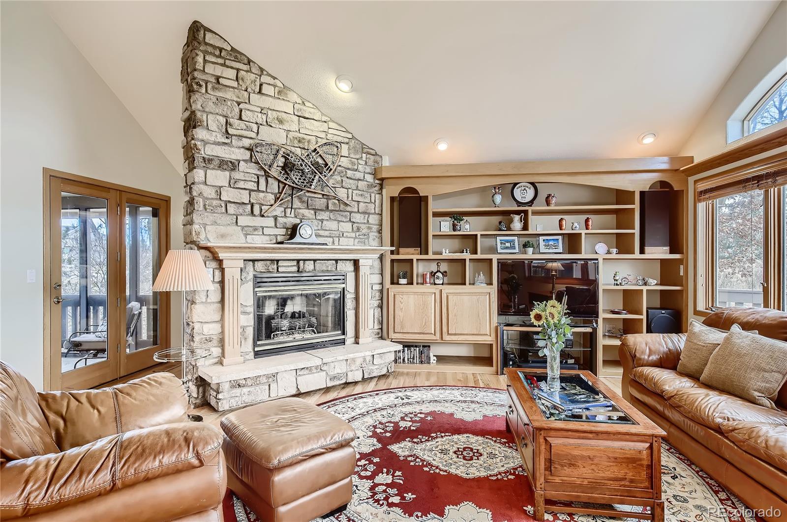 7748 Crestview Lane Niwot, CO 80504 - Photo 12 of 40 a living room with furniture a rug and a fireplace