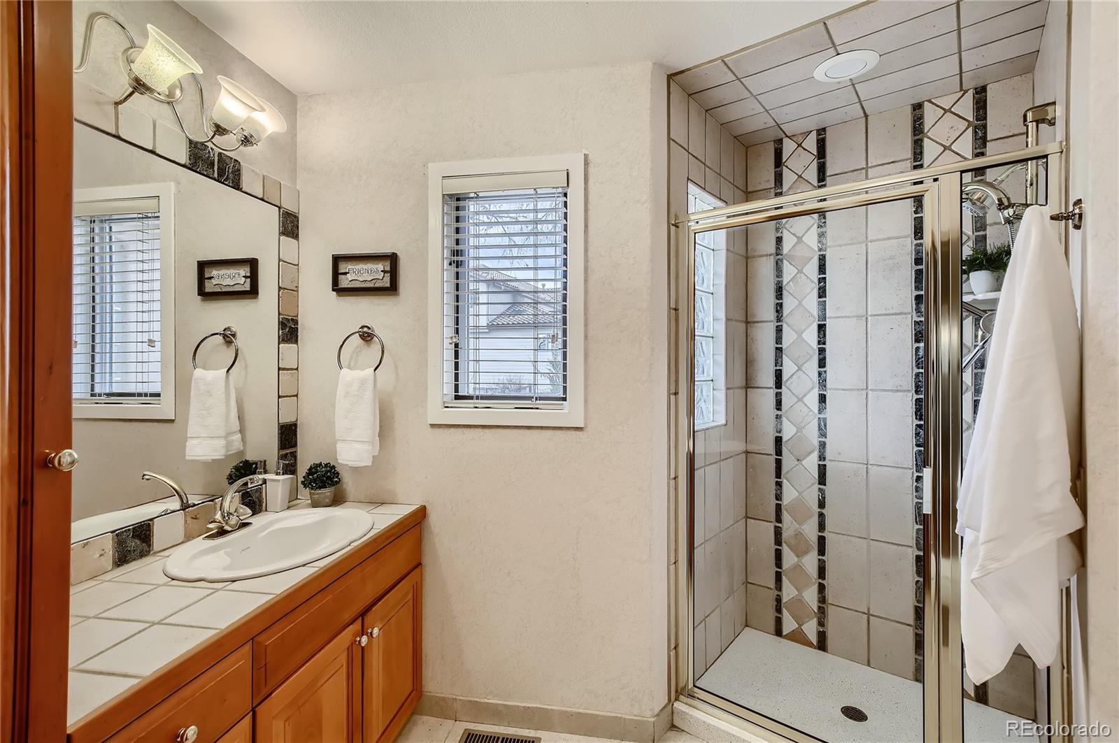 7748 Crestview Lane Niwot, CO 80504 - Photo 16 of 40 a bathroom with a double vanity sink mirror and shower