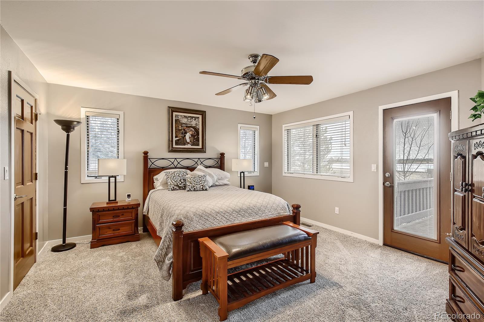7748 Crestview Lane Niwot, CO 80504 - Photo 17 of 40 a bed room with a bed and a ceiling fan