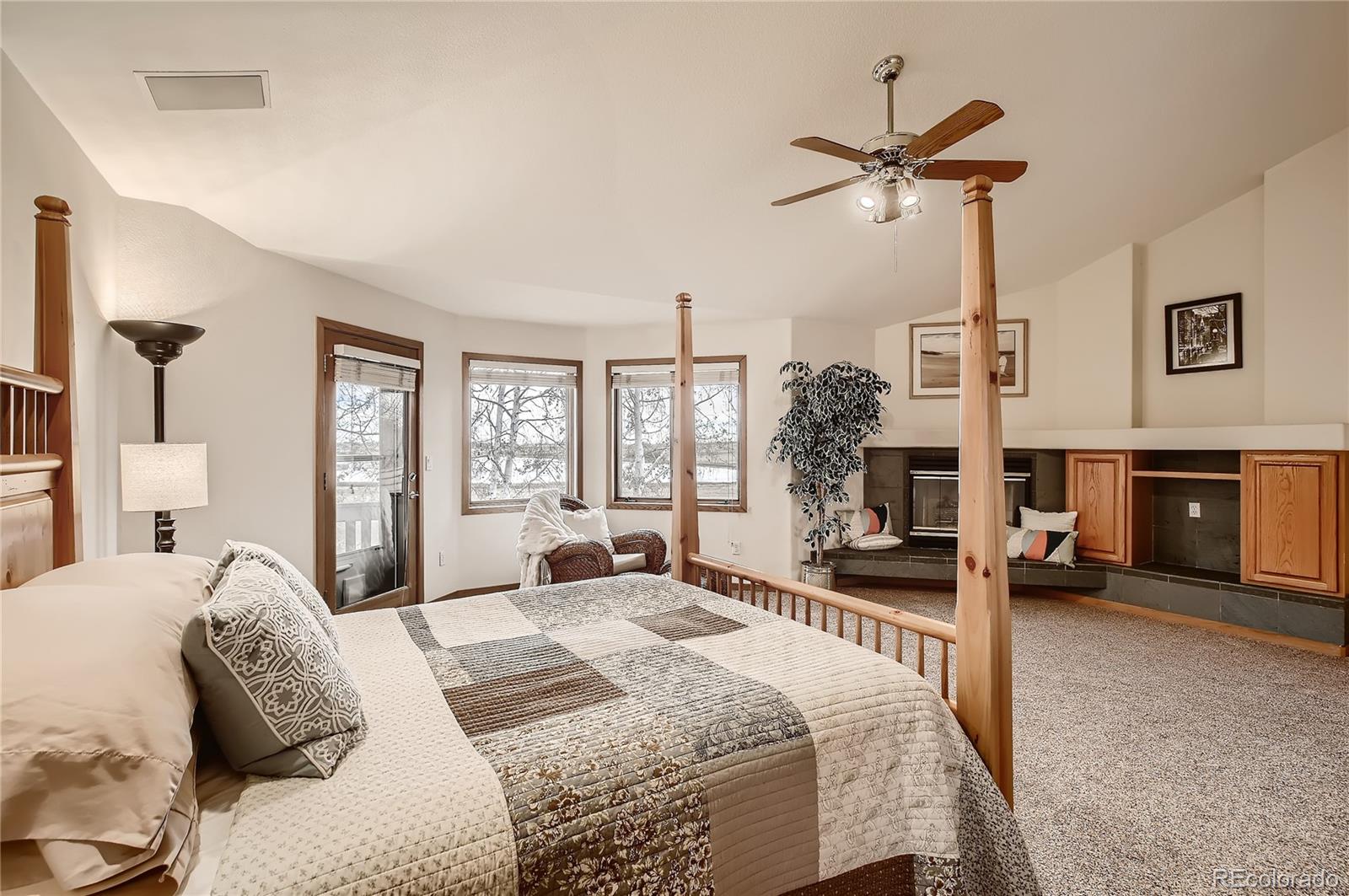 7748 Crestview Lane Niwot, CO 80504 - Photo 19 of 40 a bedroom with a bed and a chandelier