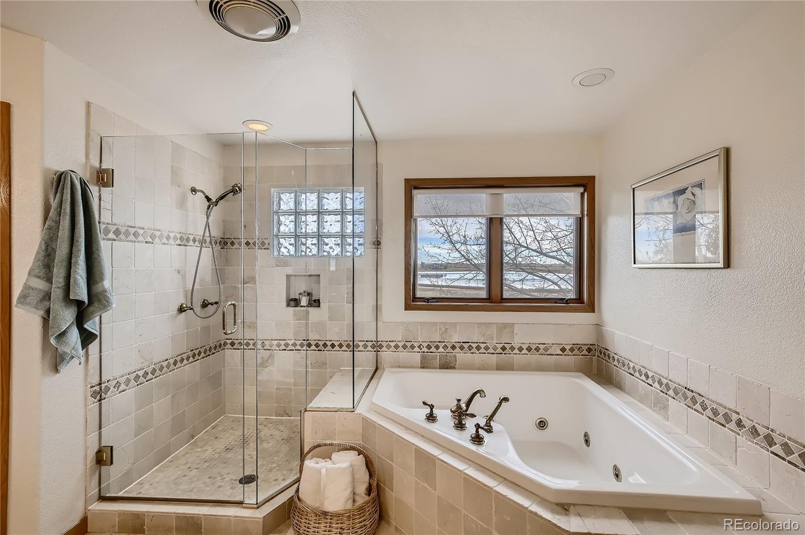 7748 Crestview Lane Niwot, CO 80504 - Photo 24 of 40 a bathroom with a bathtub a window and a shower
