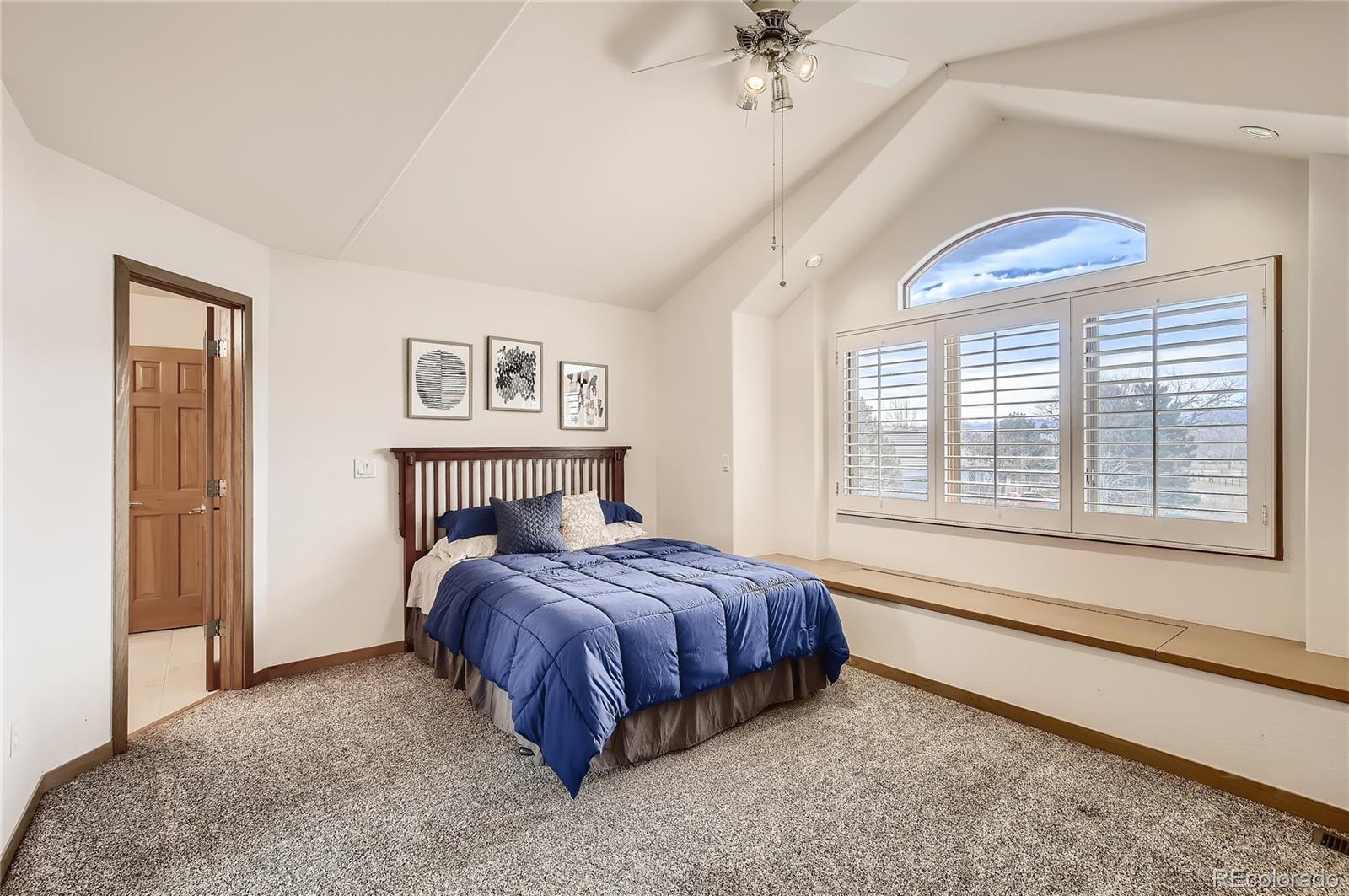 7748 Crestview Lane Niwot, CO 80504 - Photo 25 of 40 a bedroom with a bed and a large window