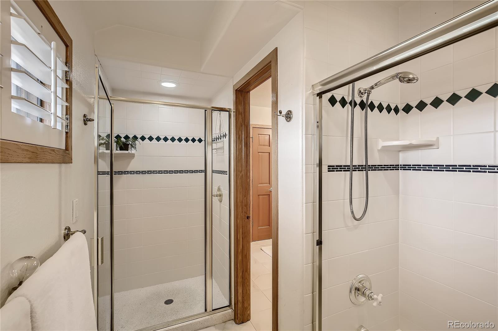 7748 Crestview Lane Niwot, CO 80504 - Photo 26 of 40 a bathroom with a glass shower door and a glass door