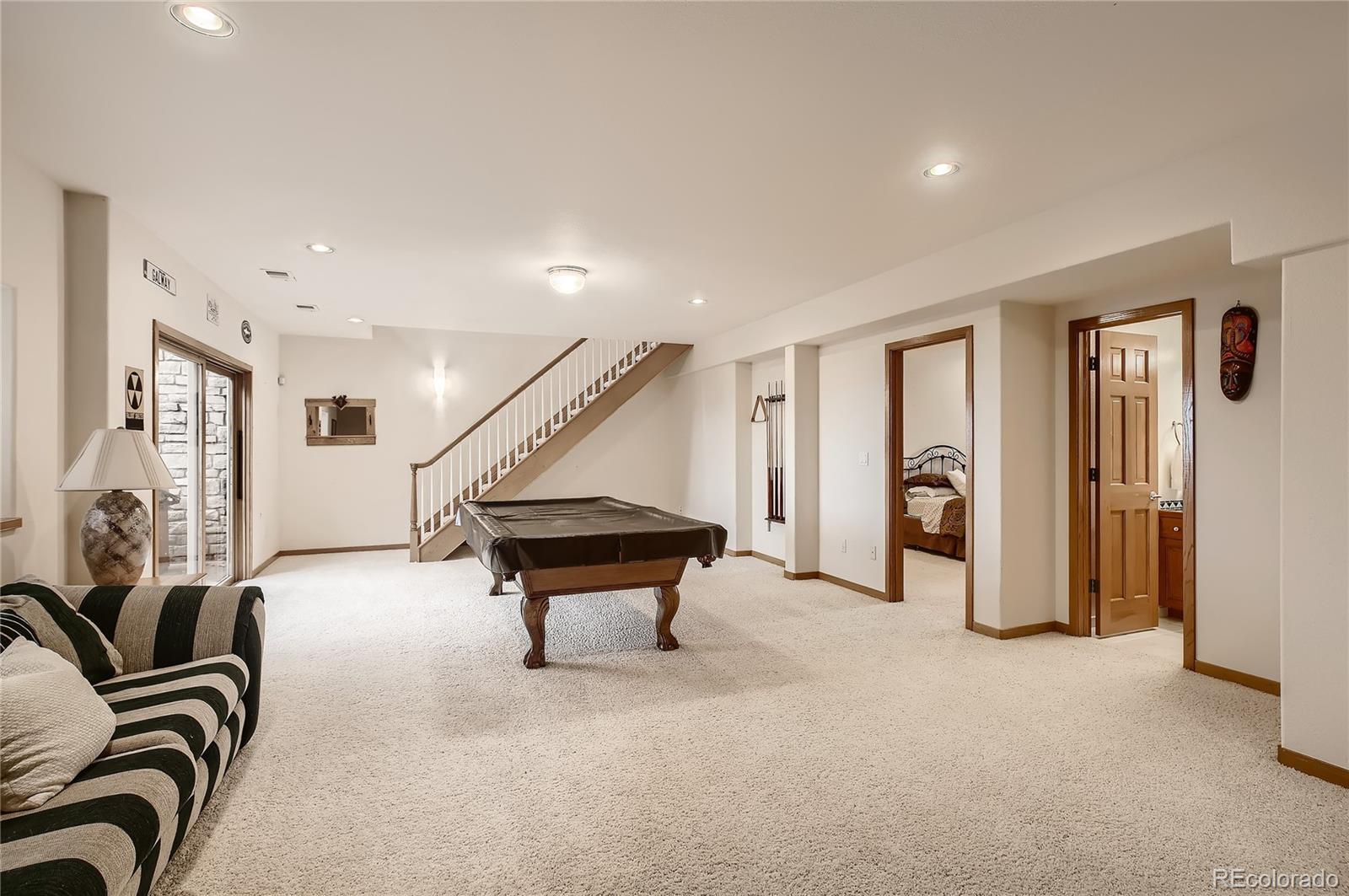 7748 Crestview Lane Niwot, CO 80504 - Photo 29 of 40 a room with lots of furniture and stairs