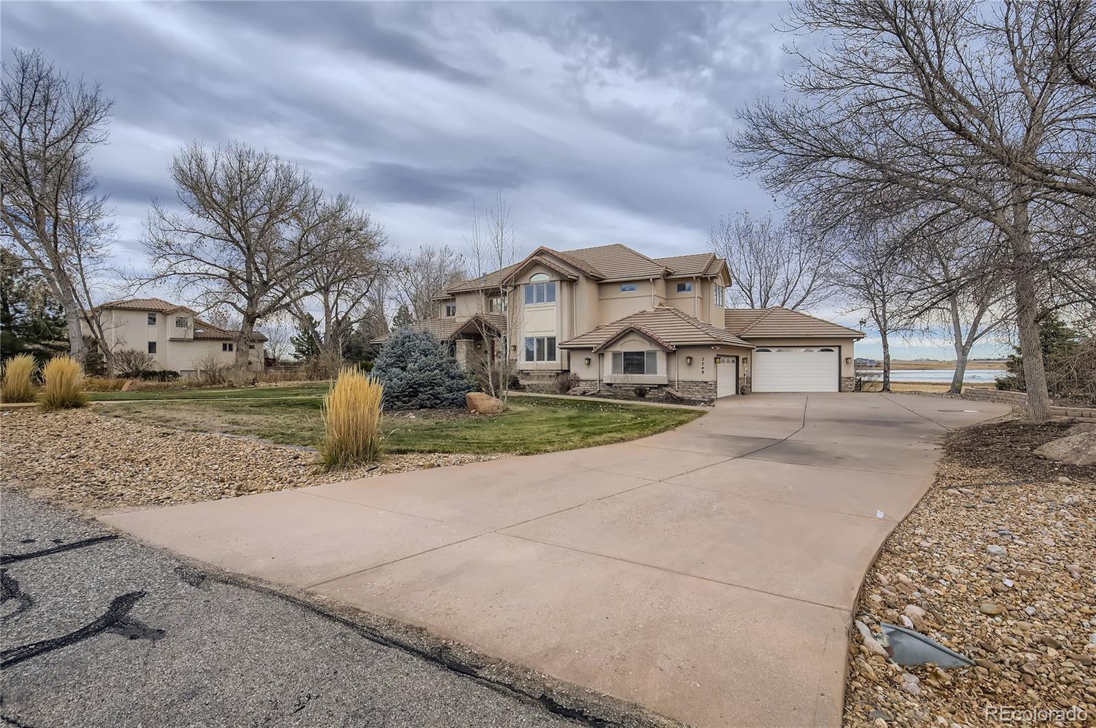 7748 Crestview Lane Niwot, CO 80504 - Photo 40 of 40 a view of a white house with a yard covered in snow