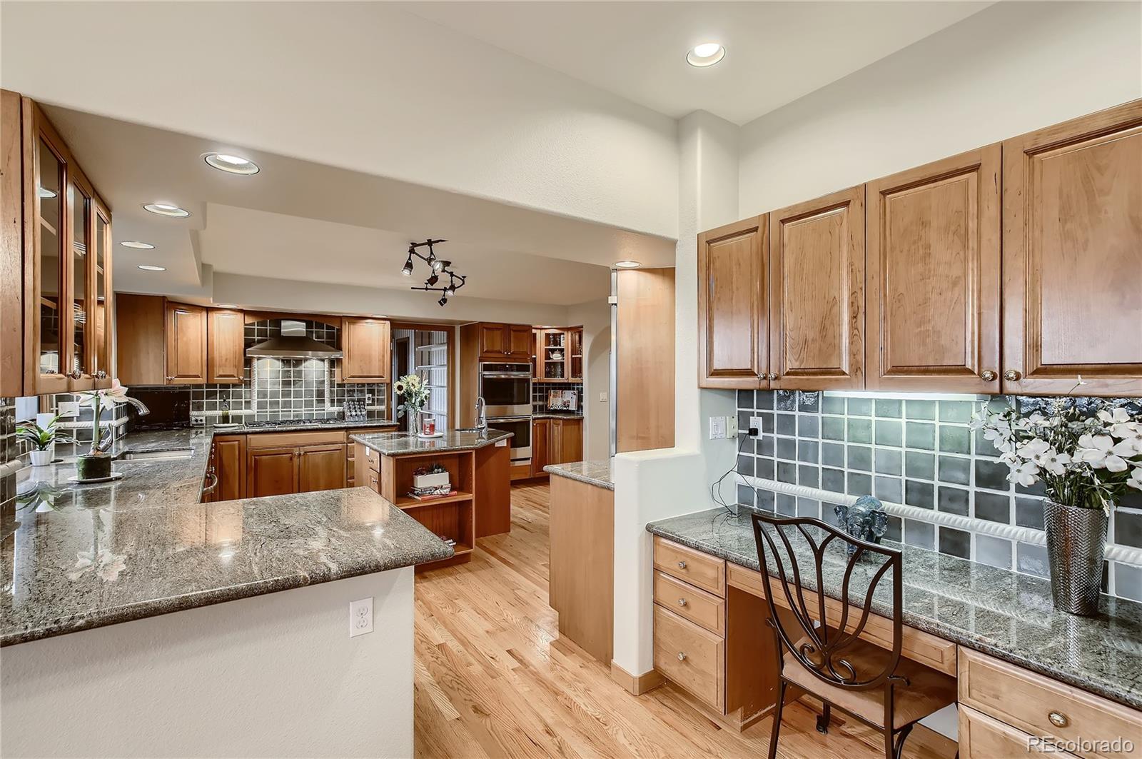 7748 Crestview Lane Niwot, CO 80504 - Photo 5 of 40 a kitchen with stainless steel appliances granite countertop a sink counter space and cabinets